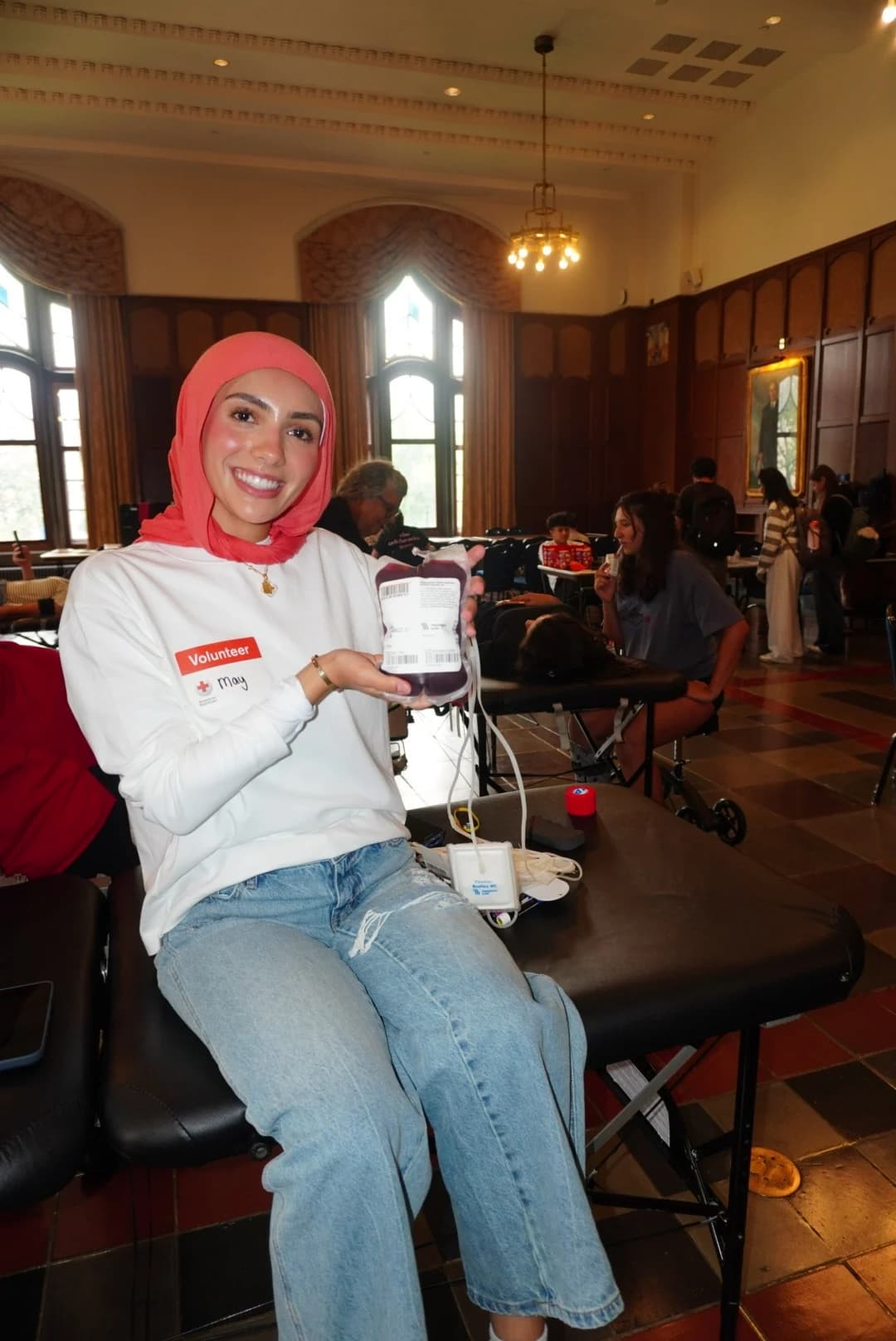 A volunteer holding a blood donation at the American Red Cross drive